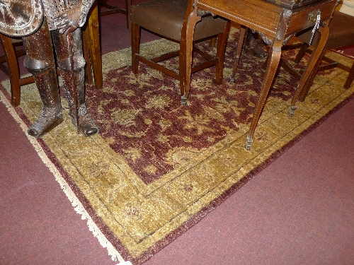 A hand knotted Peshaner Indian rug the red and camel coloured field with foliate design L 245 x W