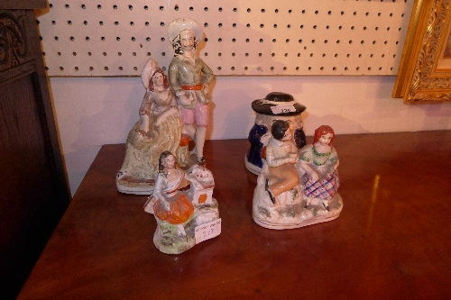 A collection of four Victorian Staffordshire figure group H 11 - 25