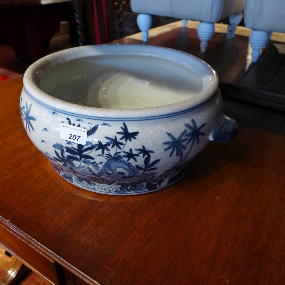 A Chinese blue and white twin handled crackleware bowl with floral references D 40