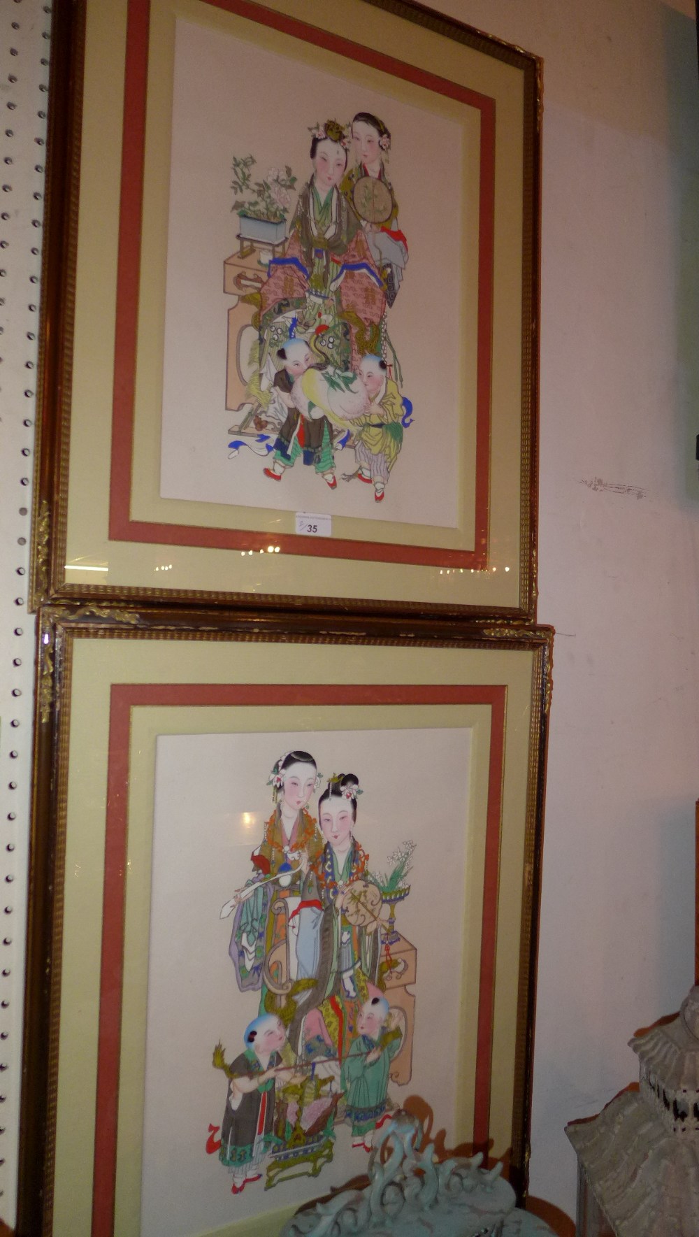 A pair of framed and glazed coloured prints figures in traditional costumes Width 38 cm x Height 68