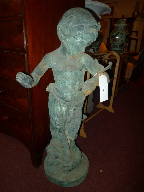 A cast metal standing garden ornament of a Putti with butterfly H 110 cm