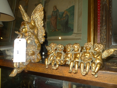 A seated gilt angel H 40 cm together with a group of six seated gilt cherubs L 35 cm