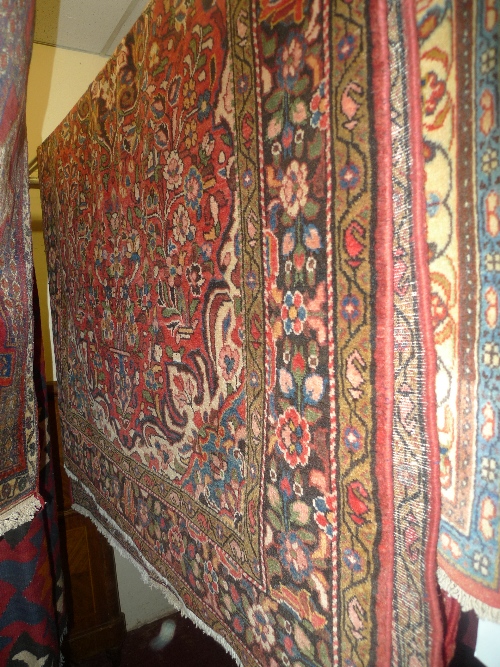 A fine North West Persian Lilihan rug 229 cm x 140 cm central pendant medallion on a terracotta