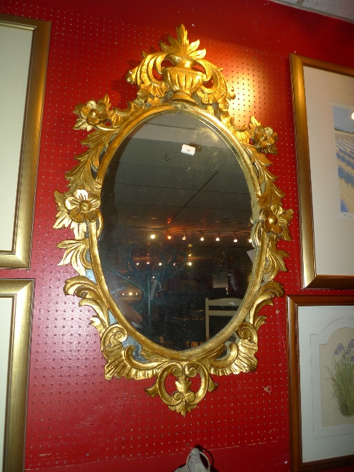 A gilt wall mirror in the Rococo taste W 70 x H 110 cm