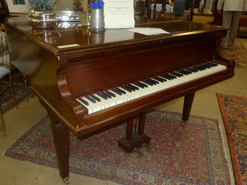 A Worthner mahogany baby grand piano