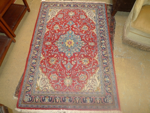 A fine North West Persian Sarouk rug, central pendant medallion on a rouge field within repeating