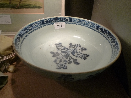 An C18th possible earlier Delft bowl with central fruit and foliate detail (slight chip to rim) W 22
