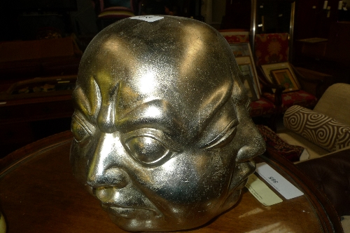 A silvered Buddha head expressions