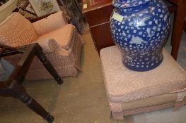 An armchair upholstered in geometric rouge fabric and matching stool W x 87cm