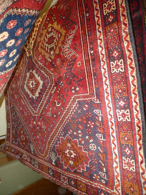 A fine South West Persian Qashgai carpet 257 cm x 168 cm with triple diamond medallions on