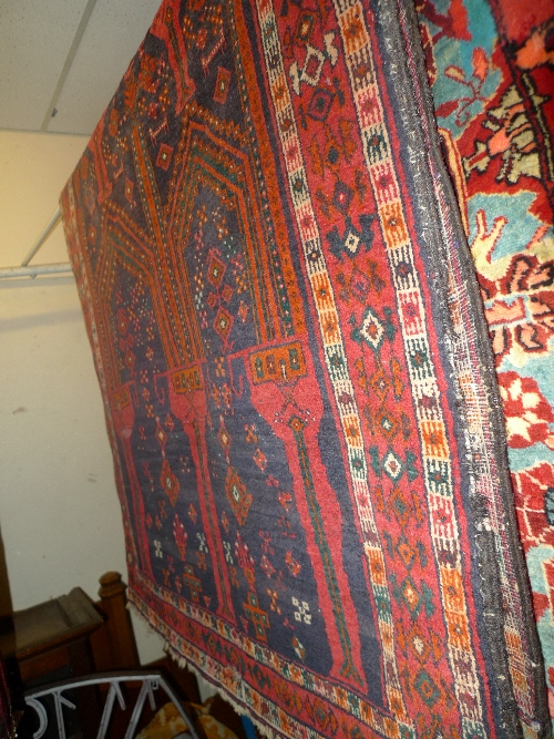 A hand knotted Persian Belouch rug the red field with bookcover design