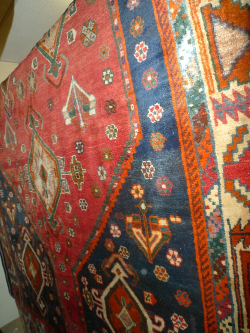 A hand knotted Persian Qashgai carpet the red field with good geometric design