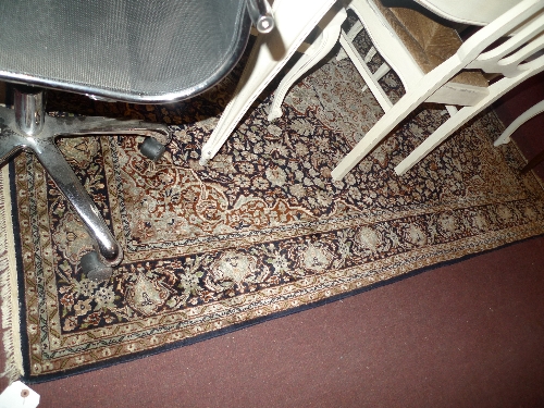 An Oriental pure silk hand knotted carpet with central diamond medallion surmounted with floral