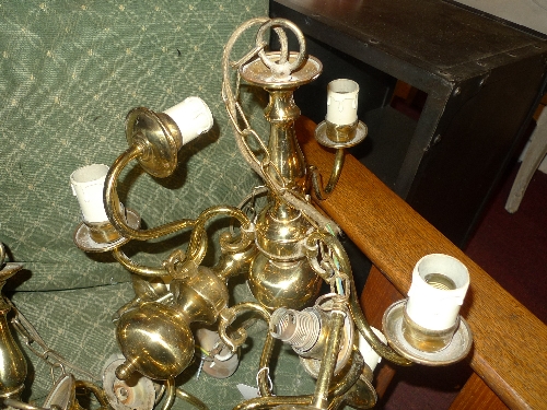 A set of four brass triple branch chandeliers