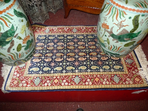 A Turkish Herkh silk hand knotted rug with allover geomantic Buteh floral motifs 110cm x 67cm