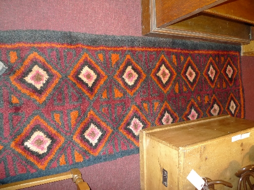 A hand knotted Aztec tribal runner the red field with repeating geometric motifs 300cm x 70cm