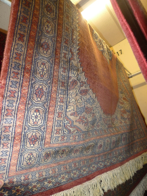 A hand knotted Persian Kashan rug the rose field with central medallions within a multi border. 180