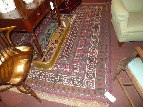 An antique Persian carpet the red and camel coloured field with geometric design. 280 x 192 cm.