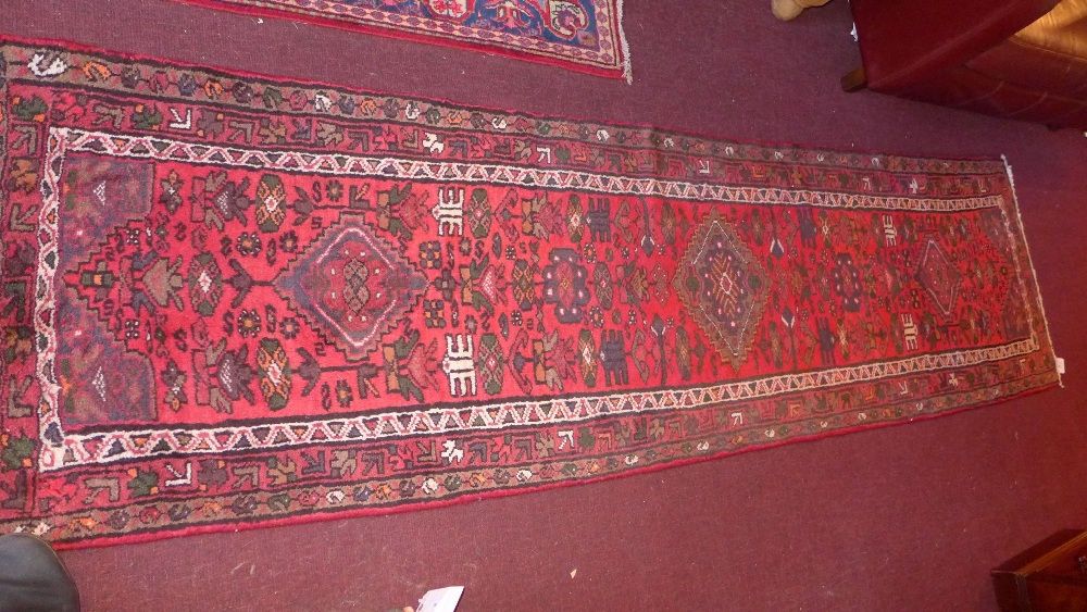 A hand knotted Persian Hamadan rug the red field with diamond motif