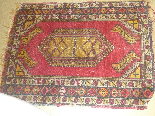 A hand knotted prayer rug the red ground with stylized detail