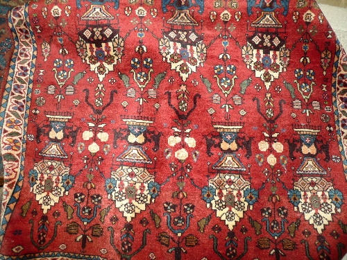 An extremely fine South West Persian Oasngai rug 150 cm x 125 cm repeating vase motifs on a