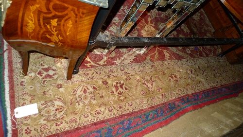 A hand knotted carpet the terracotta ground with floral pattern within beige border