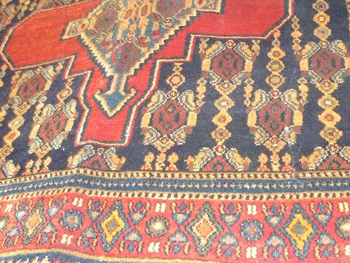 A fine North West Persian Senneh carpet 263 cm x 150 cm triple pole medallion with animal motifs