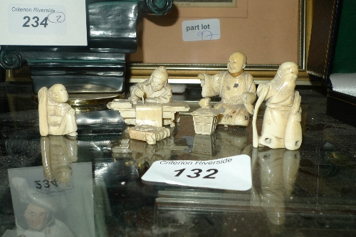 A collection of Japanese carved ivory figures and netsukes
