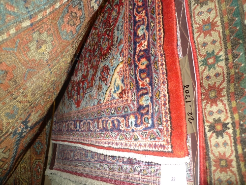 A fine central Persian Sarouk rug 138 cm x 104 cm with pendant medallion on a rouge field within