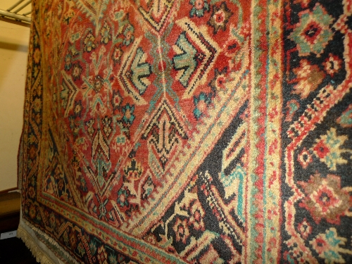 A fine old North West Persian Mahal rug with pendant medallion on a terracotta field and repeating