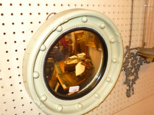 A circular convex Empire design mirror with a painted frame