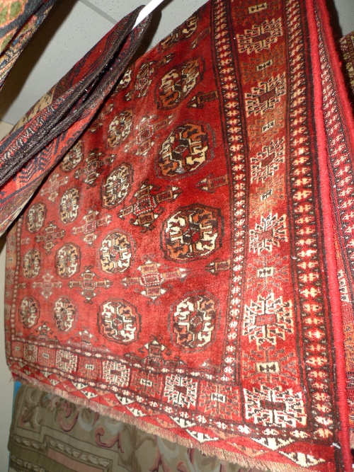 A fine North East Persian Turkoman rug 160 cm x 120 cm repeating Goul motifs on a terracotta field