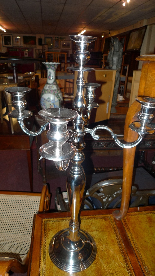 A pair of nickel plated five light candelabra of scrolling form