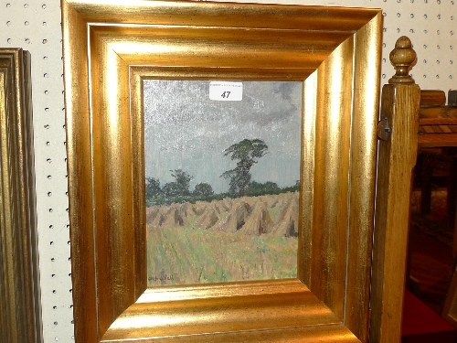 An oil on board landscape of haystacks by Clifford Hall, signed in a gilt frame