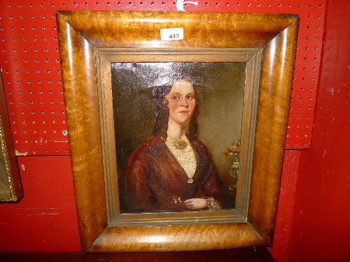 A C19th oil on canvas portrait of a well dressed lady in maple frame