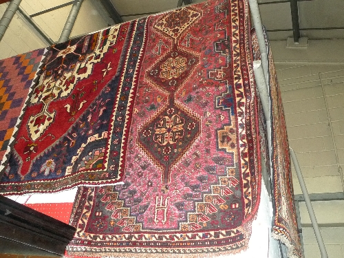 A fine South West Persian Qashgai runner 305cm x 90cm with repeating pole medallion on a terracotta