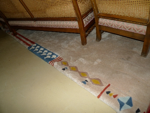 A contemporary Andrew Martin style carpet with deep beige pile