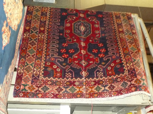 A fine North West Persian Malaten rug 220 cm x 145 cm triple pole medallion on a madder ground