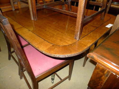 A Regency inlaid tilt top breakfast table on splayed quadruped castor supports