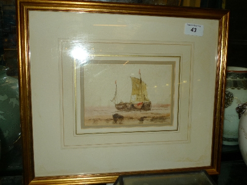A watercolour of a beached boat within gilt border and frame
