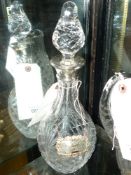 A silver collar and silver gin label cut glass decanter and stopper