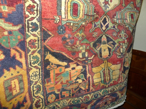 A hand knotted Persian Heriz carpet the multi coloured field with geometric design 303cm x 161cm