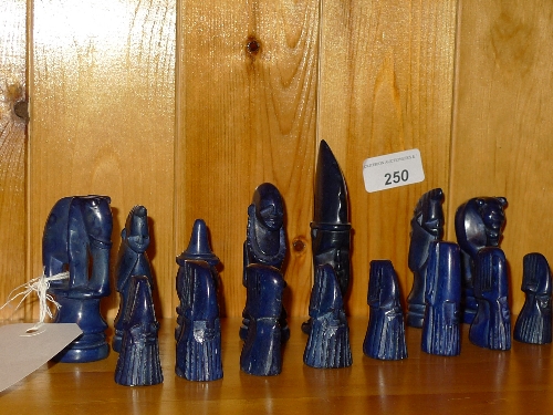 An African hard stone chess set the figures in the form of tribesman and animals