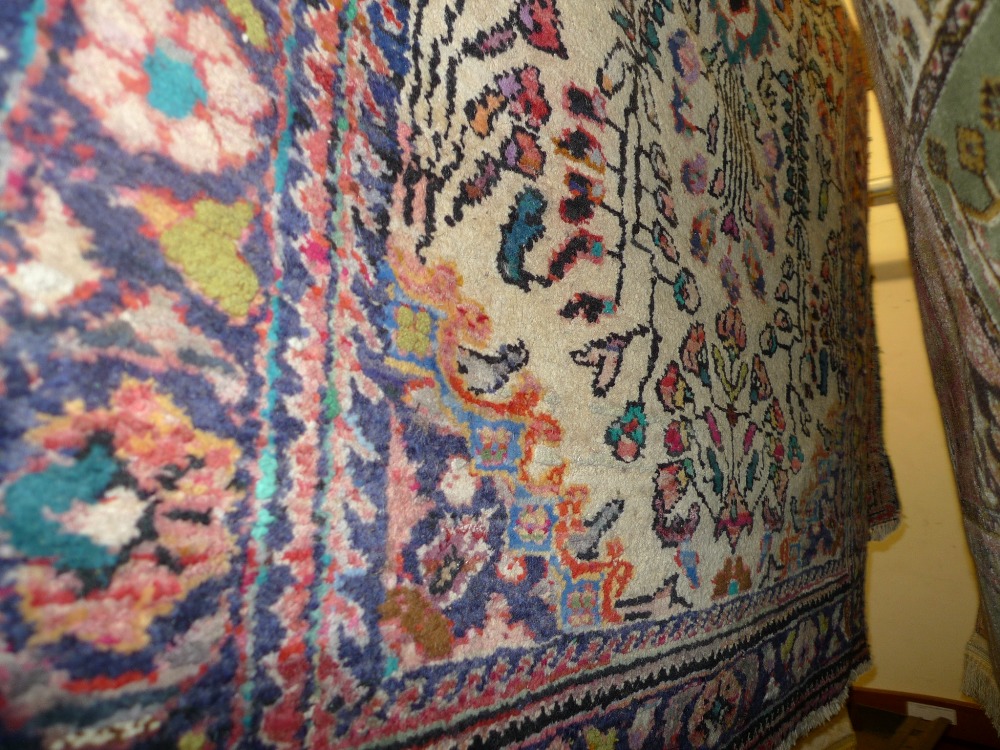 A fine North West Persian Lilihan rug with pendant medallion on a camel field within multi floral