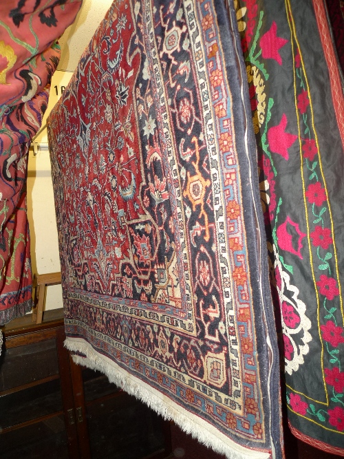 A fine Persian rug the red field with central medallion and all over foliate and geometric design