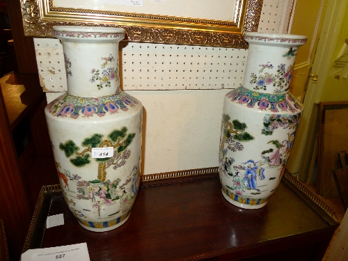 A pair of Chinese Cantonese vases the ivory glaze decorated figures in costume in naturalistic