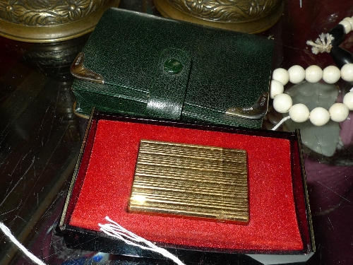 A gold plated DuPont cigarette lighter and a Asprey`s hallmarked silver mounted playing card case