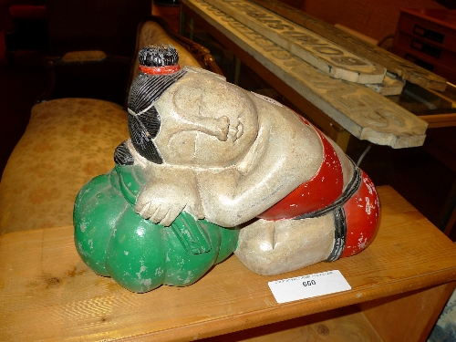 A Chinese kneeling figure in meditation