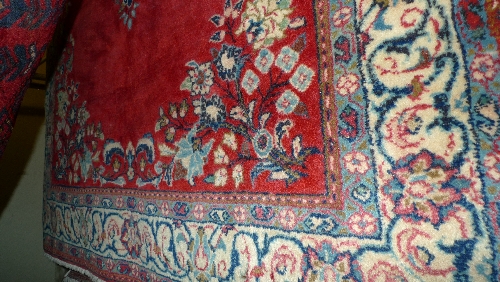 A fine central Persian Sarouk rug 157 cm x 107 cm pendant medallion on a rouge field within stylized