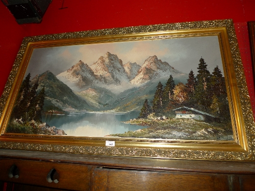 An oil on canvas alpine scene signed in a gilt frame